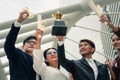 Asian business people raise hands holding trophy and winner certificate showing excite for their team success to win business Royalty Free Stock Photo