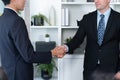 Asian business people shake hand after made successful deal. Quaint Royalty Free Stock Photo