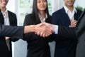 Asian business people shake hand after made successful deal. Quaint Royalty Free Stock Photo