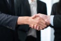 Asian business people shake hand after made successful deal. Quaint Royalty Free Stock Photo