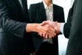 Asian business people shake hand after made successful deal. Quaint Royalty Free Stock Photo