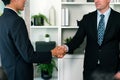 Asian business people shake hand after made successful deal. Quaint Royalty Free Stock Photo