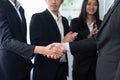 Asian business people shake hand after made successful deal. Quaint Royalty Free Stock Photo
