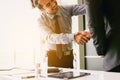 Asian business people shaking hands in office room. Royalty Free Stock Photo