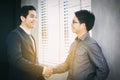 Asian Business people shaking hands and smiling their agreement Royalty Free Stock Photo