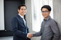 Asian Business people shaking hands and smiling their agreement to sign contract and finishing up a meeting Royalty Free Stock Photo