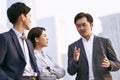 Asian business people talking outdoors Royalty Free Stock Photo