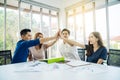 Asian Business people team with casual suit standing and giving high five at office, happy action for teamwork in the modern Royalty Free Stock Photo