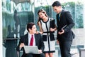 Asian business people working outside on laptop Royalty Free Stock Photo