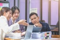 Asian business team consists of marketing staff. accountant and financial officer Help each other analyze company profits using