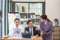 Asian business team consists of marketing staff. accountant and financial officer Help each other analyze company profits using