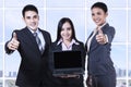 Asian business team showing blank screen on laptop Royalty Free Stock Photo