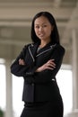 Asian Business Woman with Arms Folded Smiling Royalty Free Stock Photo