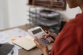 Asian Business woman calculating saving account balance with working at home, account and saving concept