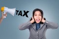 Asian business woman close her ears from megaphone with tax text Royalty Free Stock Photo