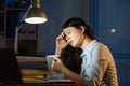 Asian business woman drink coffee refreshing working overtime la Royalty Free Stock Photo