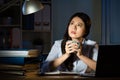 Asian business woman drink coffee working overtime late night Royalty Free Stock Photo