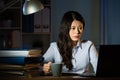 Asian business woman drink coffee working overtime late night Royalty Free Stock Photo