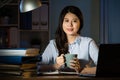 Asian business woman drink coffee working overtime late night Royalty Free Stock Photo