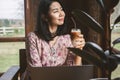 Asian business woman drinking coffee and working on computer laptop at cafe shop,  work from anywhere concept Royalty Free Stock Photo