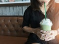 Asian business woman drinking green tea frappe. Royalty Free Stock Photo