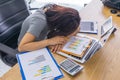 Asian business woman fall asleep on financial reports in meeting room