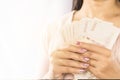 Asian business woman hand holding money planing to invest or paying Royalty Free Stock Photo