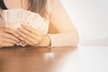 Asian business woman hand holding money planing to invest or paying Royalty Free Stock Photo