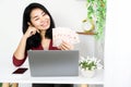 Asian business woman hand holding Thai banknotes , successful with make money online sitting with laptop and mobile phone on desk Royalty Free Stock Photo
