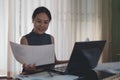 Asian business woman happy smiling and hand holding paper documents and laptop computer in the office, Work at Home Royalty Free Stock Photo