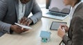 Asian business woman is having a meeting with an African American real estate agent about home insurance and investment Royalty Free Stock Photo