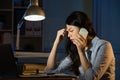 Asian business woman headache on smartphone working overtime