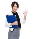 Asian business woman holding chip board with ok sign