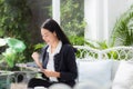 Asian business woman holding clipboard folder and gesture glad in the office. Royalty Free Stock Photo