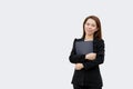 Asian business woman holding folder and smiling at camera in black suit isolated on white color background Royalty Free Stock Photo