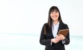 Asian business woman holding smart mobile tablet in office - Young smiling Chinese girl ready for working on digital marketing Royalty Free Stock Photo