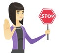 Asian business woman holding stop road sign.