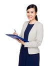 Asian business woman jot down information on file pad Royalty Free Stock Photo