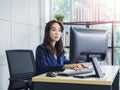 Asian business woman long hair in blue suit working with desktop computer in office Royalty Free Stock Photo