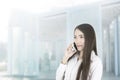 Asian business woman office worker communicating with mobile phone. Royalty Free Stock Photo