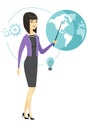 Asian business woman pointing at a globe. Royalty Free Stock Photo