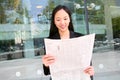 Asian Business Woman Reading Newspaper Royalty Free Stock Photo