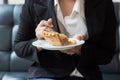 Asian business woman in relax time and eating apple pie in coffee shop. Royalty Free Stock Photo