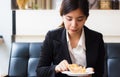 Asian business woman in relax time and eating apple pie in coffee shop. Royalty Free Stock Photo