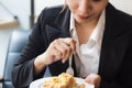 Asian business woman in relax time and eating apple pie in coffee shop. Royalty Free Stock Photo