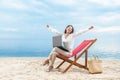 Asian business woman relax when working with laptop sitting in the beach chair on beach Royalty Free Stock Photo