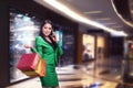 Asian business woman with shopping bags talking on the phone Royalty Free Stock Photo