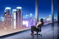 Asian business woman sii on chair looking at the city Royalty Free Stock Photo