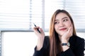 Asian business woman smile pointing up to space beside her Royalty Free Stock Photo