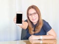 Asian business Woman smiling and holding smart phone device. Smart phone with blank screen. Business Contact concept. Royalty Free Stock Photo